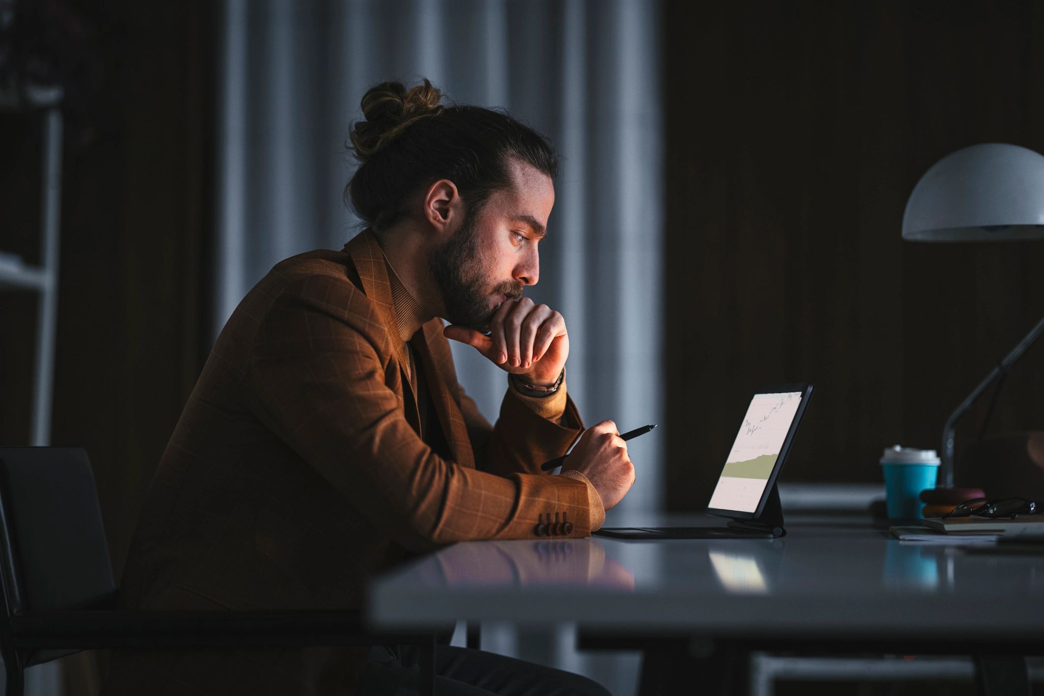 Analyst working on a laptop in a low-light office
